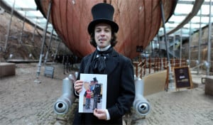 Joe Teanby in his role as Mr Brunel, holding the photo that changed his life