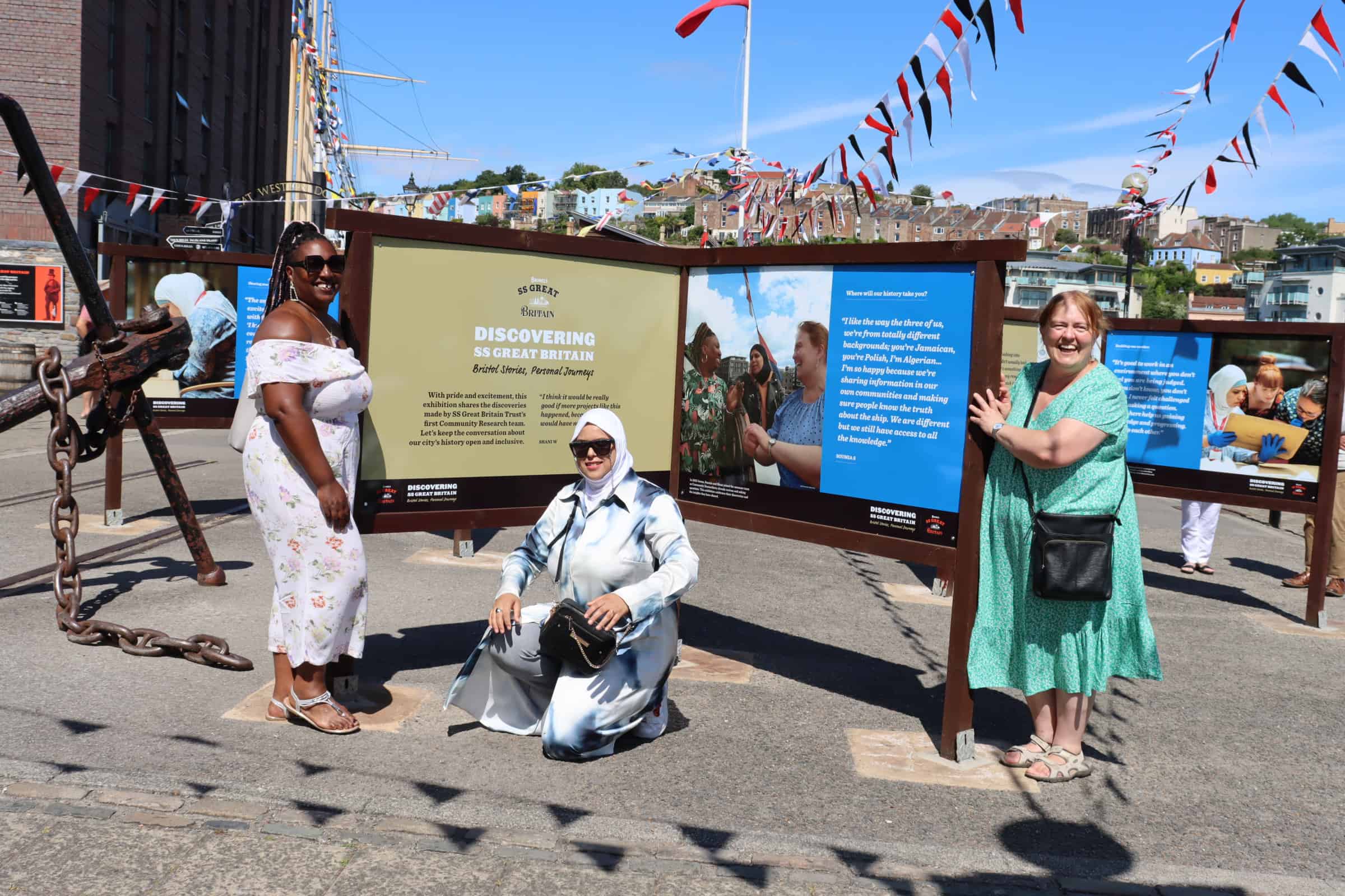 Three women in front of an information board