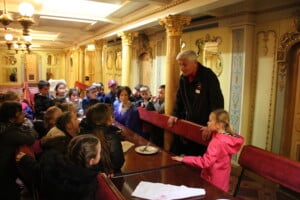 Children listening to a tour guide on the ship